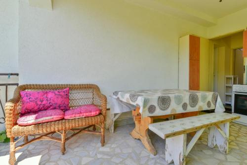 a room with two chairs and a table and a table and bench at Baka Zlata Apartments in Petrovac na Moru