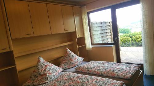 ein Schlafzimmer mit zwei Kissen neben einem Fenster in der Unterkunft Ferienwohnung Haus Weitblick in Medebach