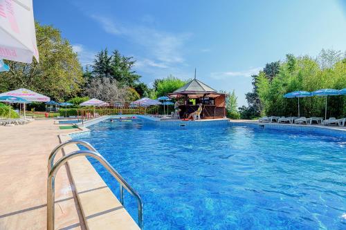 a large swimming pool with a gazebo at International House of Journalists Resort in Golden Sands