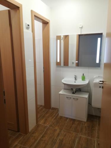 a bathroom with a white sink and a mirror at Jura Hotel in Nürnberg