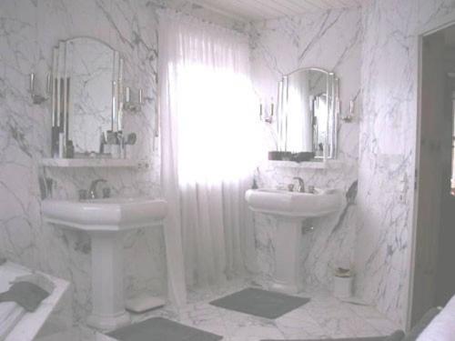 a white bathroom with two sinks and two mirrors at My sweet home in Sauerlach