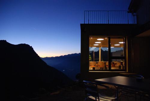 a room with a table and a window with a view at Berggasthaus Wasenalp in Brig