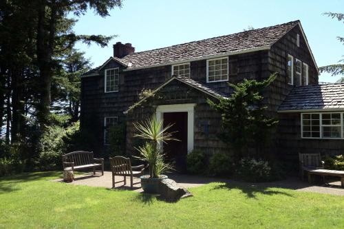 an old house with a potted plant in the yard at Whispering Seas with Hot Tub! in Newport