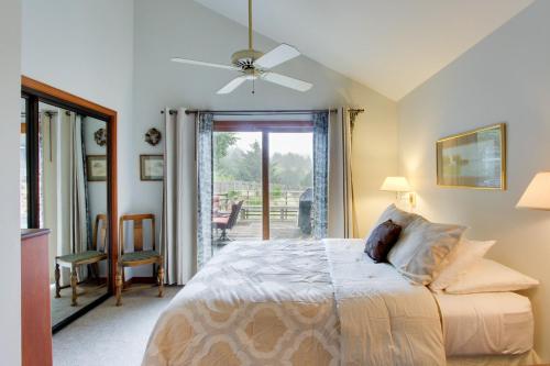 a bedroom with a bed with a ceiling fan at Chapman Cottage in Cannon Beach