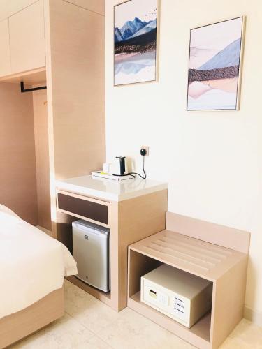 a bedroom with a bed and a nightstand with a drawer at Season Inn Hotel in Barka
