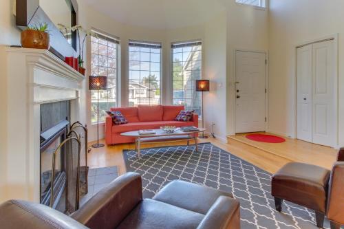 a living room with a red couch and a fireplace at Sunset Beach House in Seaside