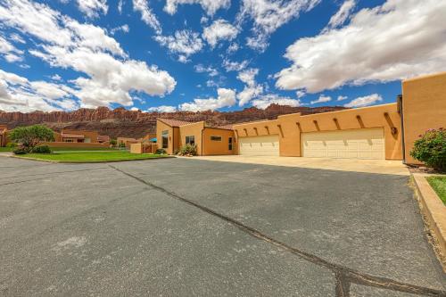 a house with a driveway in front of a mountain at Rim Village T2 in Moab