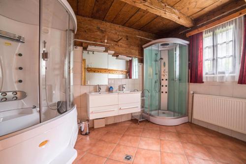 a large bathroom with a shower and a sink at Obervostlhaus - Sehr schöne gemütliche Almhütte der besonderen Art in Ebene Reichenau