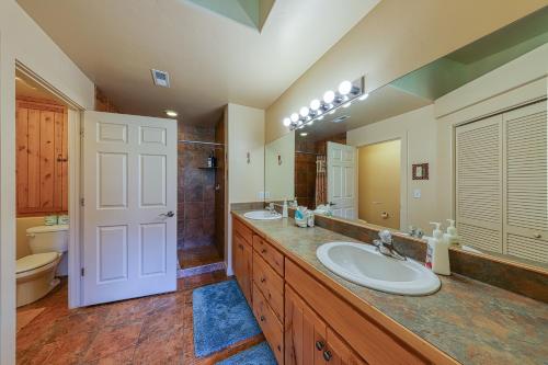 a bathroom with two sinks and a large mirror at Rim Village T2 in Moab
