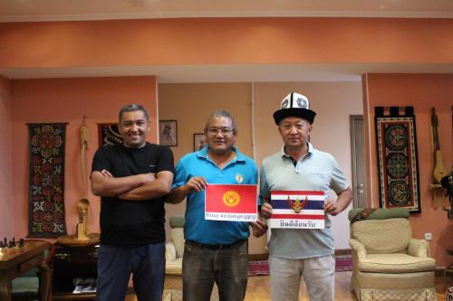 a group of three men holding up a sign at Tagaytay Karakol Hotel in Karakol