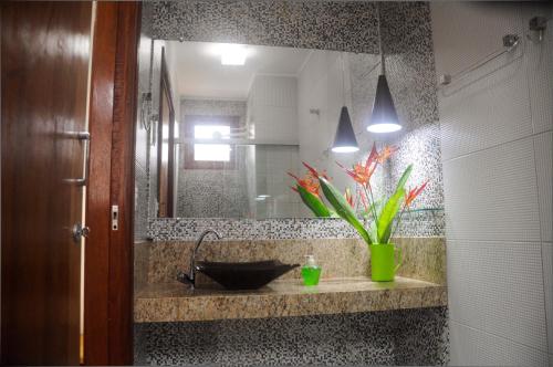 La salle de bains est pourvue d'un lavabo et d'un miroir. dans l'établissement Cardeiro Flat-S.M.Gostoso, à São Miguel do Gostoso