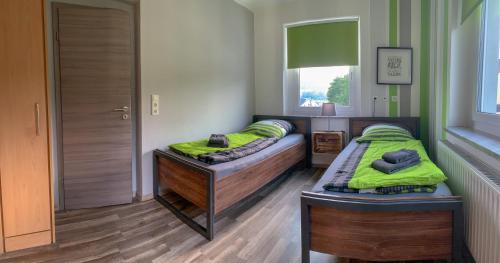 a bedroom with two beds and a window at Ferienwohnung Herold in Olbernhau