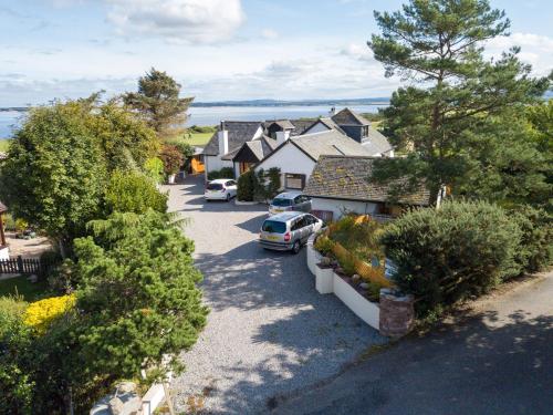 an aerial view of a house with cars parked in a driveway at The Mended Drum in Fortrose
