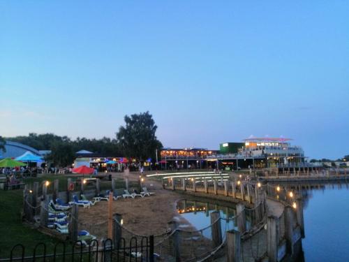 a night view of a marina with lights on at Caravan for rent at Tattershall Holiday Park in Tattershall