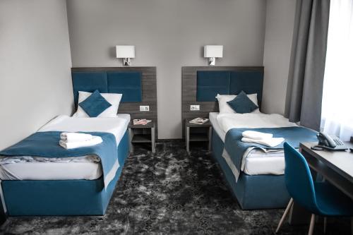 Ένα ή περισσότερα κρεβάτια σε δωμάτιο στο Hotel Sleep Wrocław