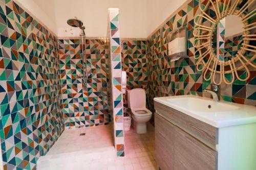 a bathroom with a sink and a toilet and a mirror at Villa Verde in Marrakesh