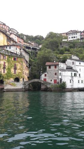 a bridge over a body of water with buildings at Gli Ulivi di Nesso in Nesso