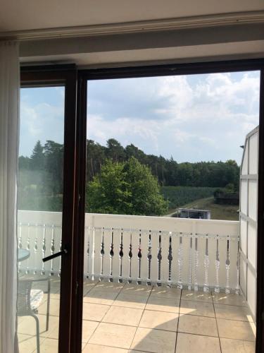 a view from a sliding glass door of a balcony at Pension Ottenheide in Schloß Holte-Stukenbrock