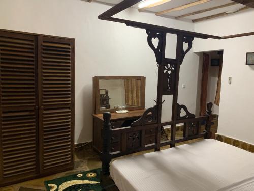 a bedroom with a bed and a mirror at Villa Ameera Malindi in Malindi