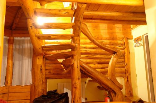 a wooden room with a ladder in a room at Casa Puelo Hostería y Cabañas in Lago Puelo