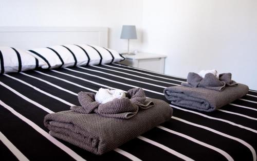 a bedroom with two beds with towels on them at La Primera Duna - Residencial Las Dunas in Corralejo