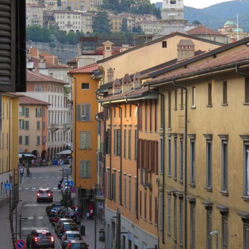 uitzicht op een straat met gebouwen en auto's bij BERGAMO CENTER NICE ROOM in Bergamo