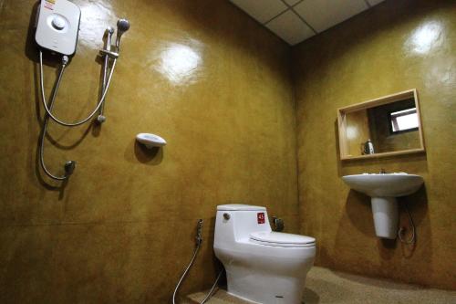 a bathroom with a toilet and a sink at Superkids Resort in Phitsanulok