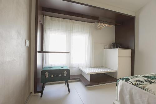 a bedroom with a bed and a window at Hedoné Design Experience B&B in Agrigento
