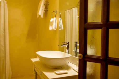 a bathroom with a white bowl sink on a counter at Villa Kololo in Kampala