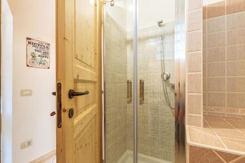a bathroom with a shower with a glass door at bedbike Baunei in Baunei