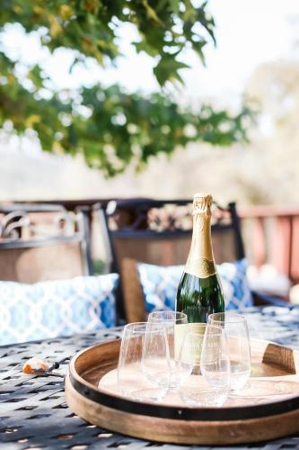 a bottle of champagne and wine glasses on a table at Moon Ranch - a gateway to Yosemite in Mariposa