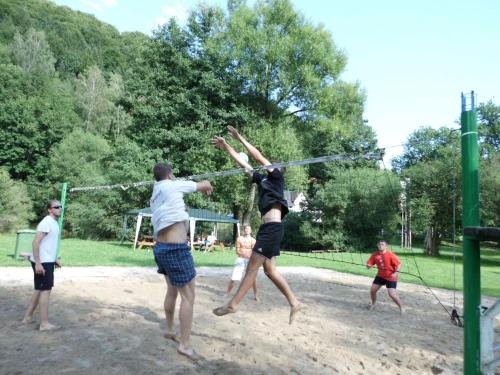 a group of people playing a game of volleyball at Green Valley Park in Stárkov