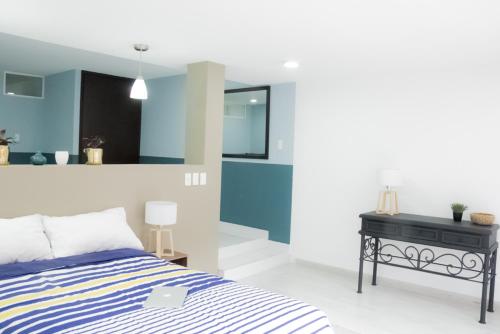 a bedroom with a bed and a black desk at Privada de Horacio 18 Residences in Mexico City