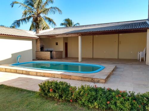 a swimming pool in the backyard of a house at Beach House in Flecheiras