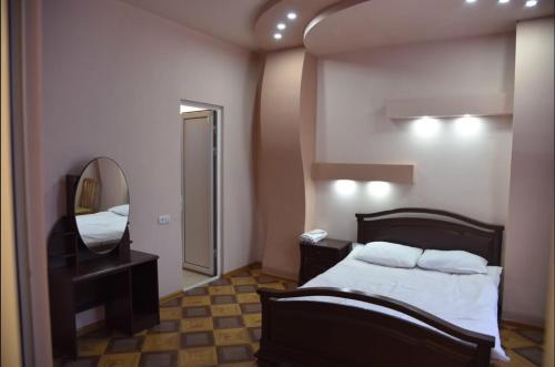 a hotel room with a bed and a mirror at Urartu Complex in Yerevan
