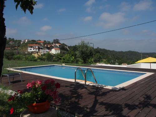 a swimming pool on the roof of a house at Casa Branca in Covas