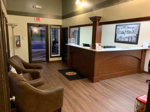 a waiting room with chairs and a reception desk at Super 8 by Wyndham Huron in Huron
