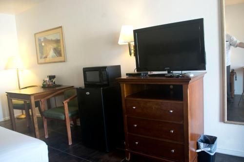 a hotel room with a flat screen tv on a dresser at Rio Del Sol Inn Needles in Needles