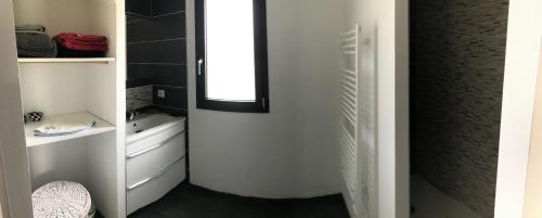 a small bathroom with a mirror and a sink at Villa avec piscine privée, vue sur mer et plage à pied 800m in Saint-Jean-de-Luz