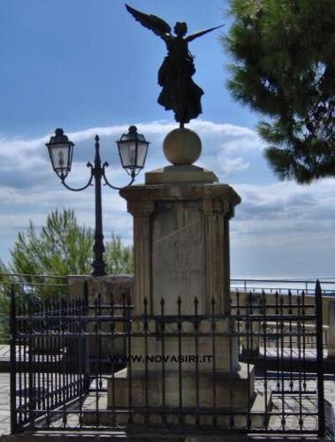 a statue of an angel sitting on top of a fence at Casa Vacanze " MELA " in Nova Siri