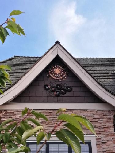 a roof of a house with a clock on it at Sunny Island by White Rock B&B in White Rock