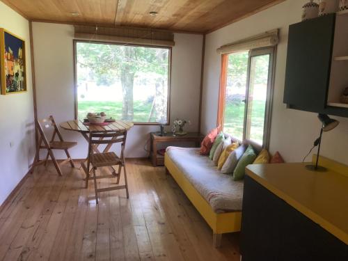 a living room with a couch and a table at Cabaña Lago Largo in Coihaique
