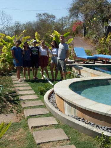 a group of people standing next to a swimming pool at Pier26 Bali Homestay in Nusa Dua