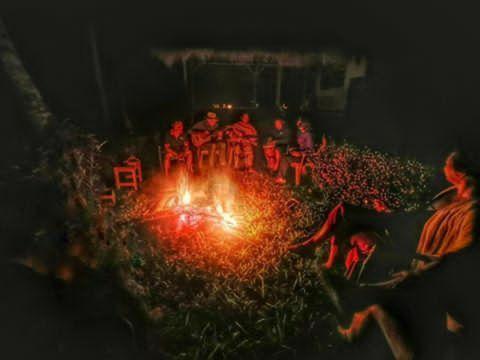 a group of people sitting in front of a stage at Tereng Wilis bungalows in Tetebatu