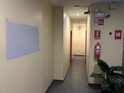 a hallway with a white board on the wall at Manantail Hotel No.003 in Puente Piedra