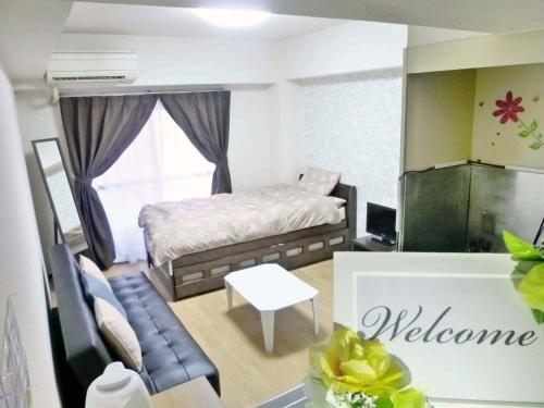 a small bedroom with a bed and a table at Free bike and free WIFI 204 Take it easy in Kyoto