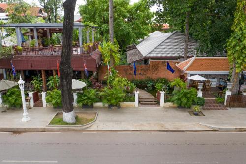 a building with a staircase leading into a courtyard at La Rivière d' Angkor Resort in Siem Reap