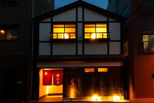 a house with lights in the windows at night at YADOYA Asakusa-Honkan in Tokyo
