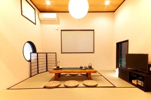 a living room with a table and a tv at YADOYA Asakusa-Honkan in Tokyo
