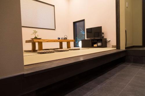 a living room with a table and a tv at YADOYA Asakusa-Honkan in Tokyo